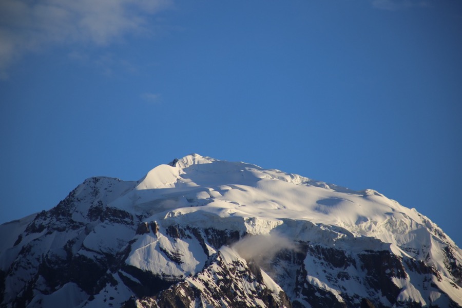A sunlit snow-covered peak