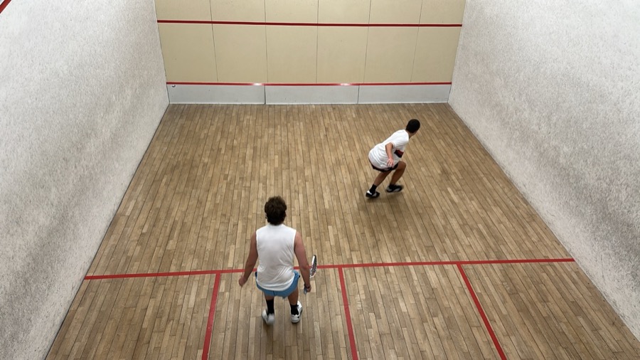 Talha playing squash on court