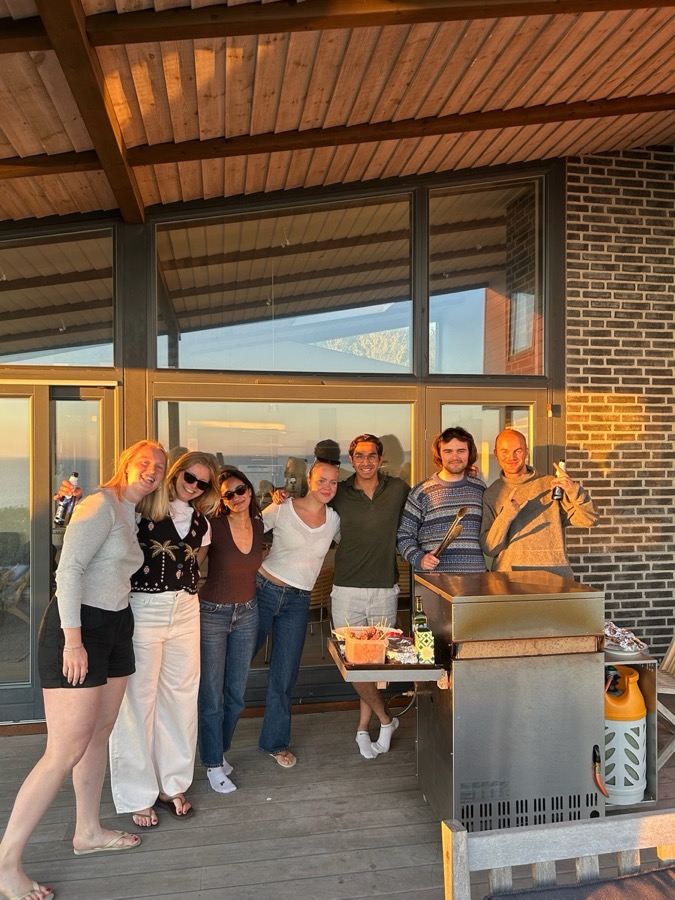 Talha with a group of friends on a terrace at sunset